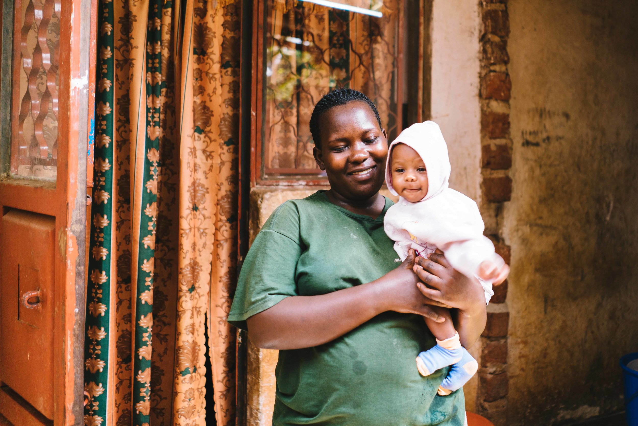 Esther with her new baby. Photo by Adam Kingman.