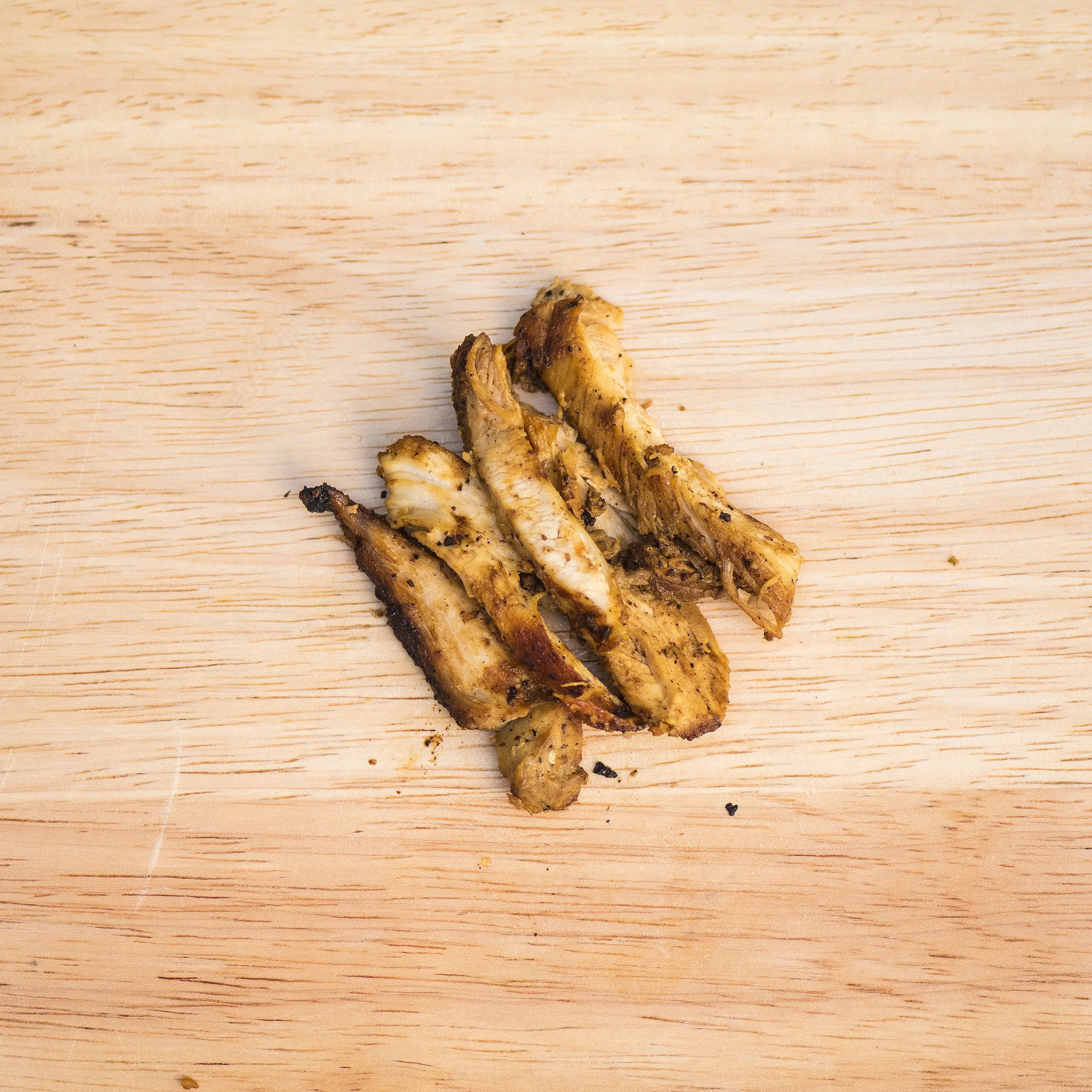seared chicken thigh The building blocks of most Northern Chinese chicken marinades are ginger, rice wine, and salt. We take that as a starting point and add galangal, garlic, cumin, and rice vinegar. The chicken thighs are then split and hard-seared on the griddle.