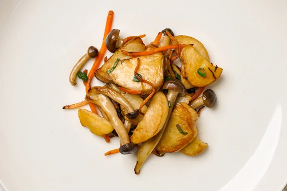 king oyster mushrooms At Junzi, we use king oyster mushrooms, a magnificently thick and buttery mushroom native to China. The mushrooms are traditionally toasted for color and stir-fried with carrots, soy sauce, and scallions. We’ve known for a while that the mushrooms are a favorite main for our regulars.