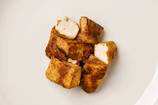 griddle-seared tofu What's cool with our tofu is that we cook our tofu with tofu: at the last stage of grilling our tofu, we baste crisped tofu bits in a sauce made of soy, aromatics, and fermented tofu.