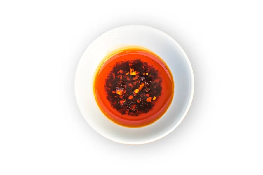 chili oil Almost all Chinese restaurants either carry sriracha or make their chili oil. At Junzi, we make ours with Tianjin chilies, sichuan peppercorns, and smoky cayenne. This is the garnish we recommend to give meals a kick.
