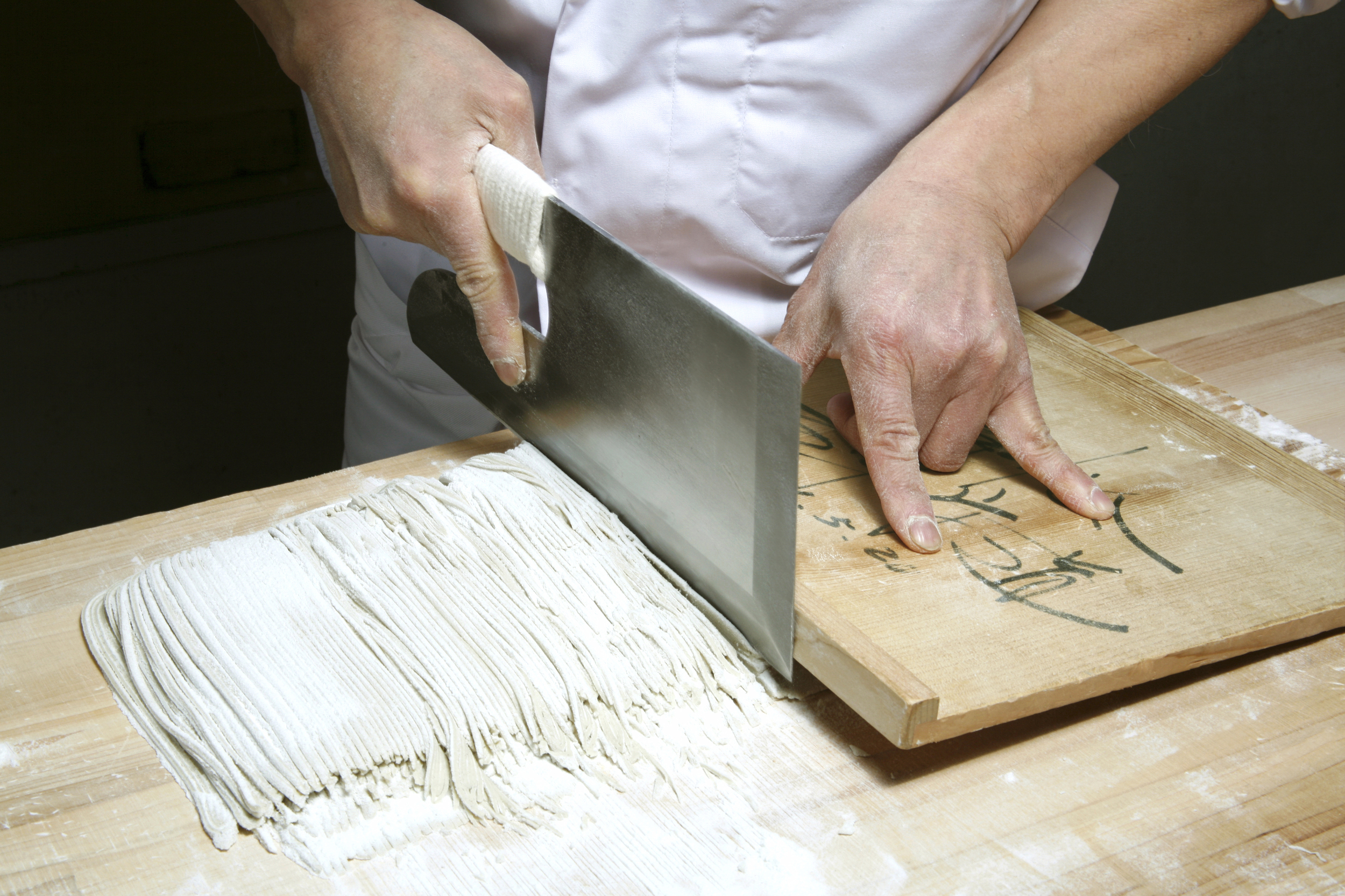 shuji cuts folded soba dough into  noodles.jpg