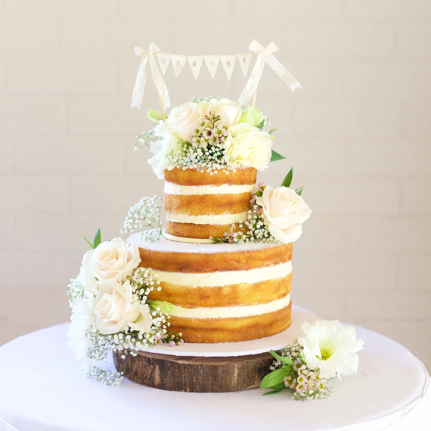 A Naked Wedding Cake Adorned With Gorgeous, Fresh Blooms. Cake & Flower Styling By Byron Bay Cake Boutique.