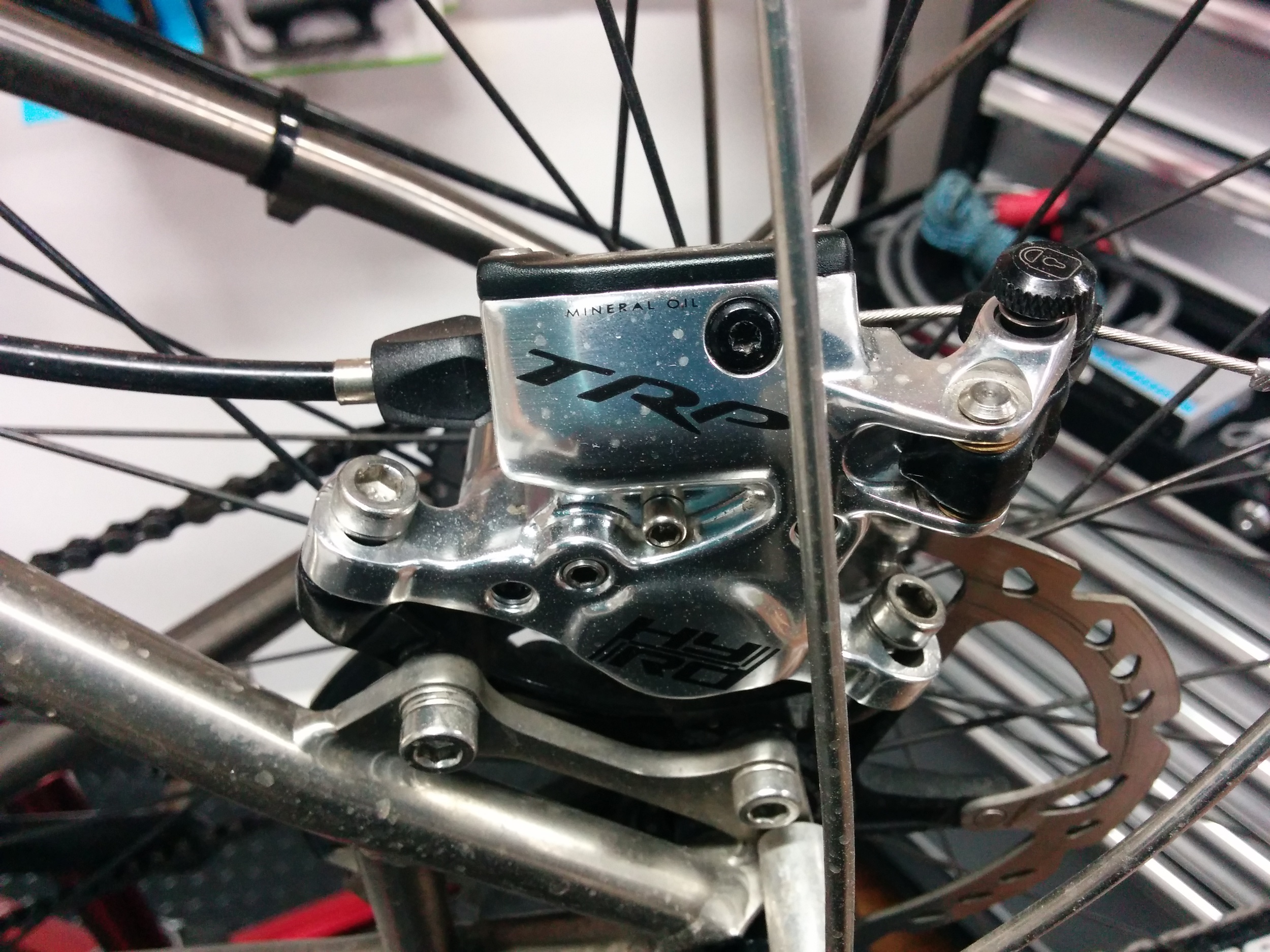 Undo the cable clamp bolt and caliper bolts.