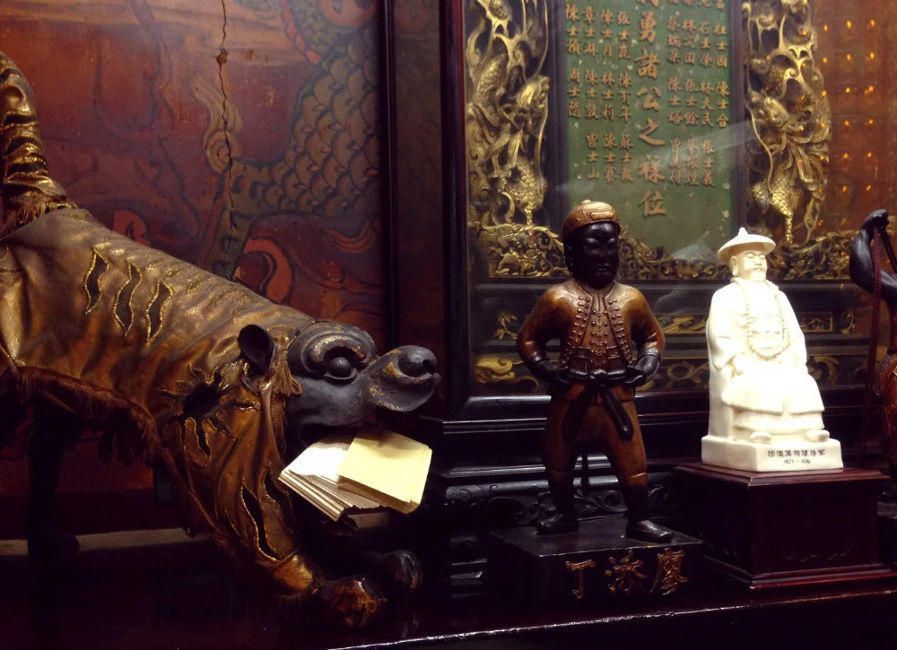 There are red placards written in Chinese, English, and Japanese at each station, so you’ll be able to understand the overall meaning of the remaining shrines. However, some statues deserve special attention, like Liao Tian-ding (廖添丁), the so-called Robin Hood of Taiwan, perched rather jauntily here in the center.