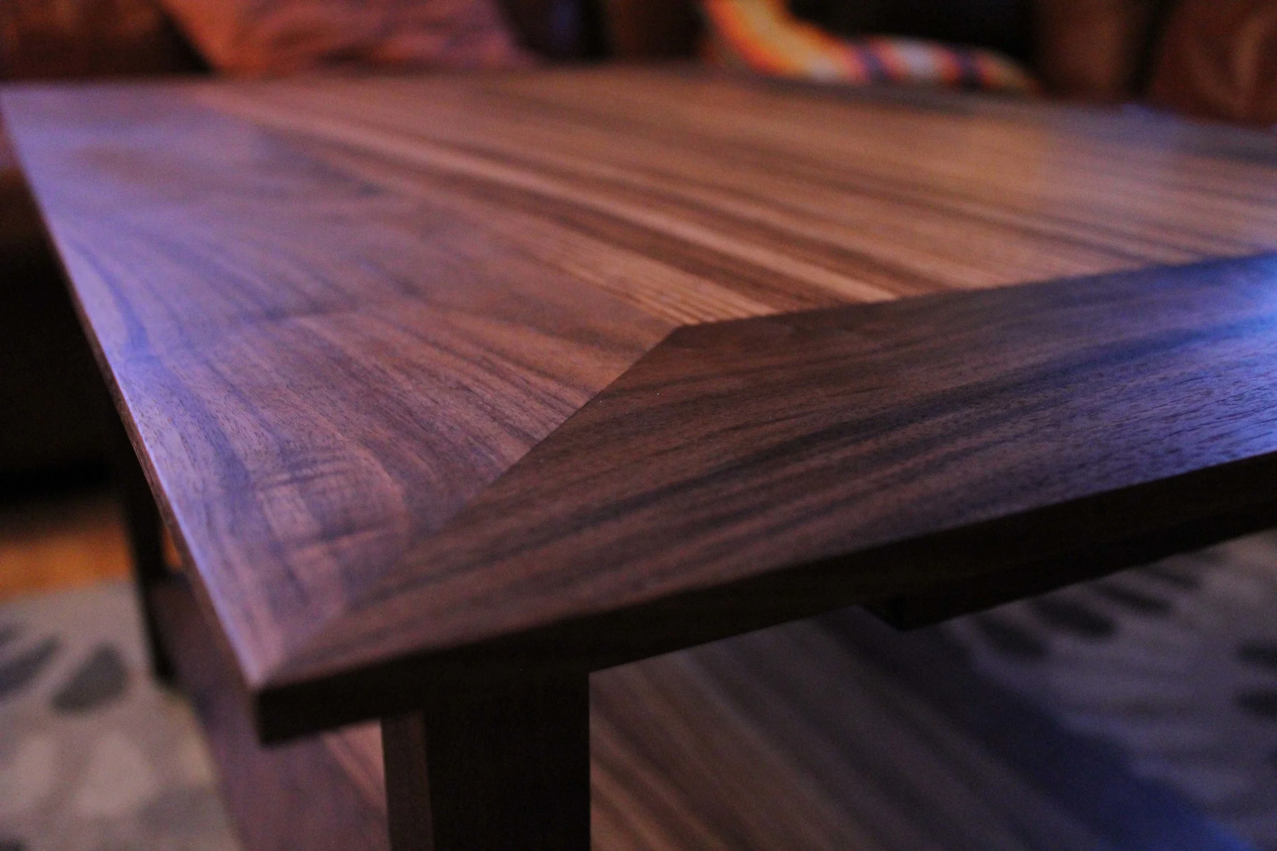  This coffee table is made from North American black walnut, with book-matched zebrawood veneers, and finished with teak oil. 