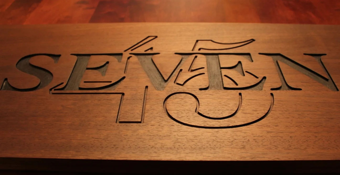  This sign was commissioned for a private residence, to hang above a home bar that has been nicknamed "The 7:45 Bar". &nbsp;The material is Peruvian Walnut, treated with Skidmore's Liquid Beeswax Finish. &nbsp;The design was etched into the wood usin