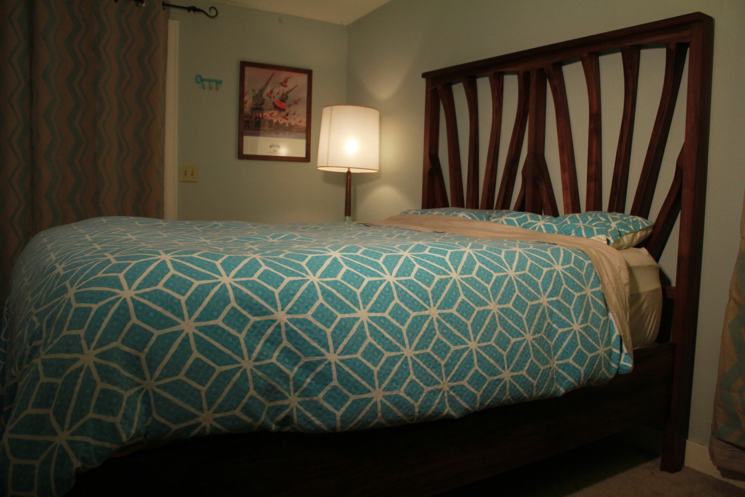 This bed frame was built out of North American black walnut and hand-finished with Skidmore's beeswax finish. All the wood came from the same walnut tree, which had been felled in Eastern Washington. The curved ribs that make up the head