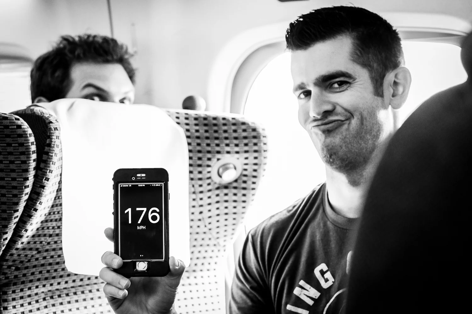 Mike Martin verifies the speed of the bullet train using an iphone app. My favorite part of this image is Clint Foreman peaking from behind the seat.