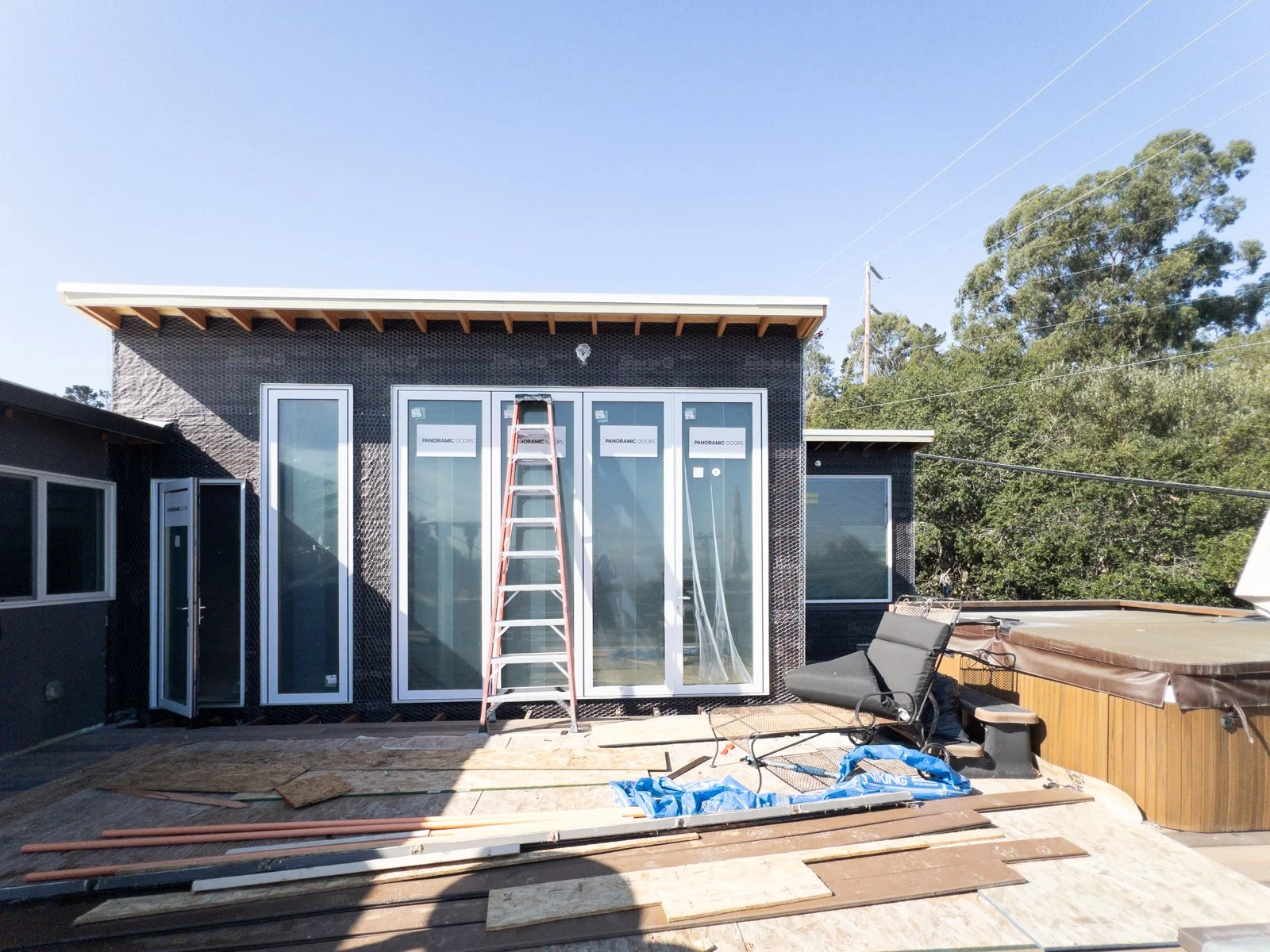  View of large scale moving glass panels in living room during construction 