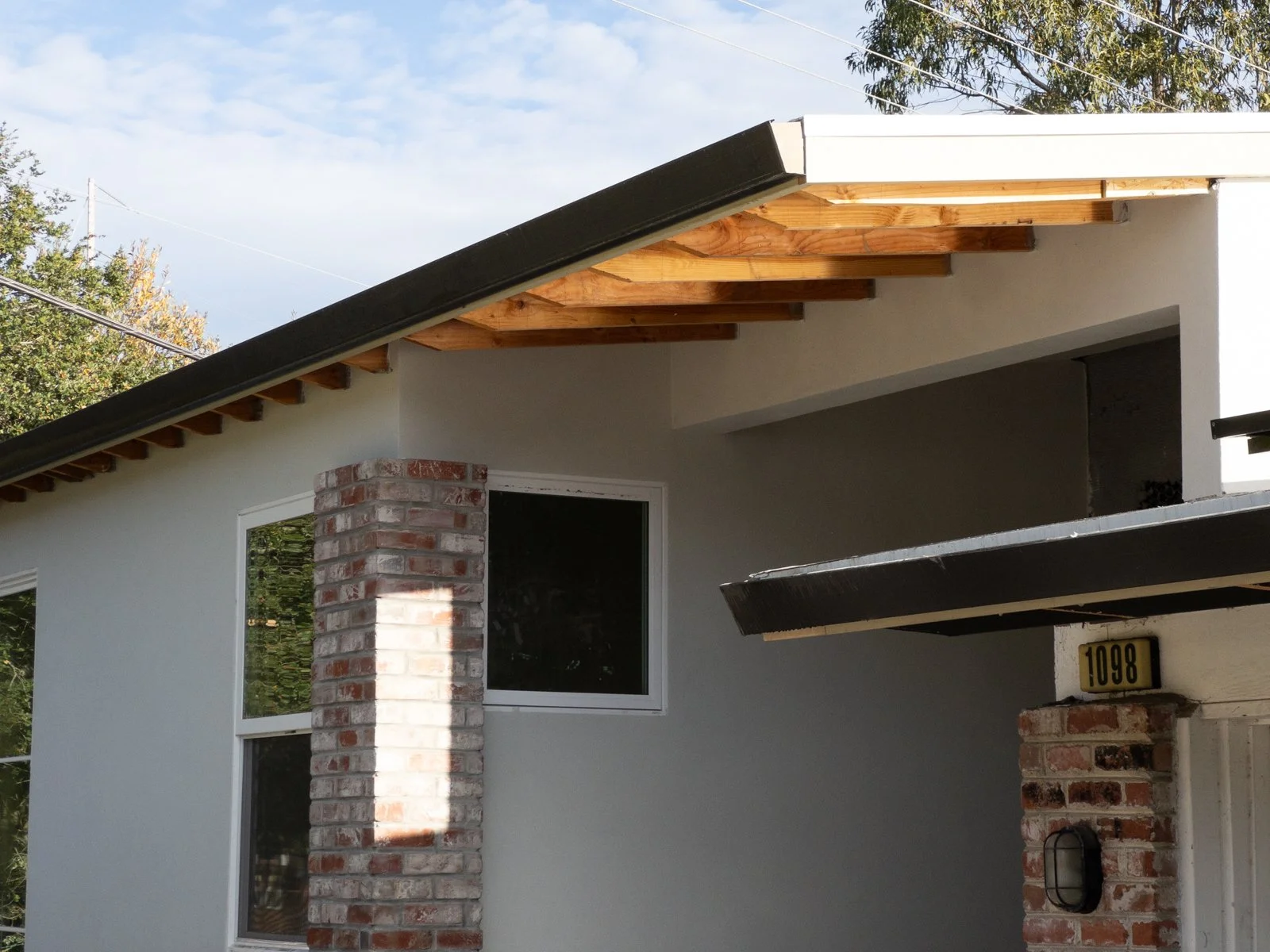  View of completed front entry with brick cladding to match existing 
