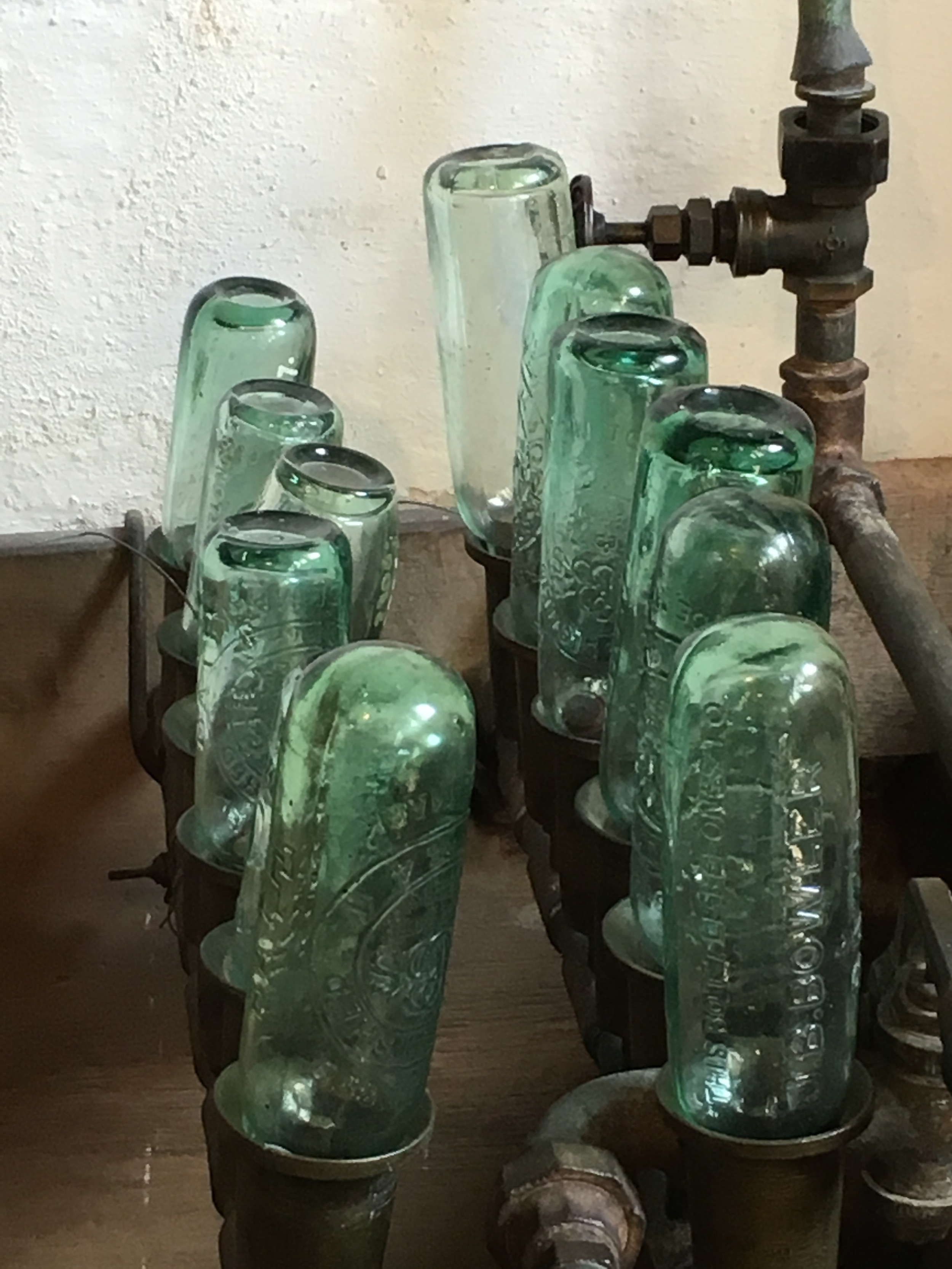  A line-up of bottles from the same soda factory. 