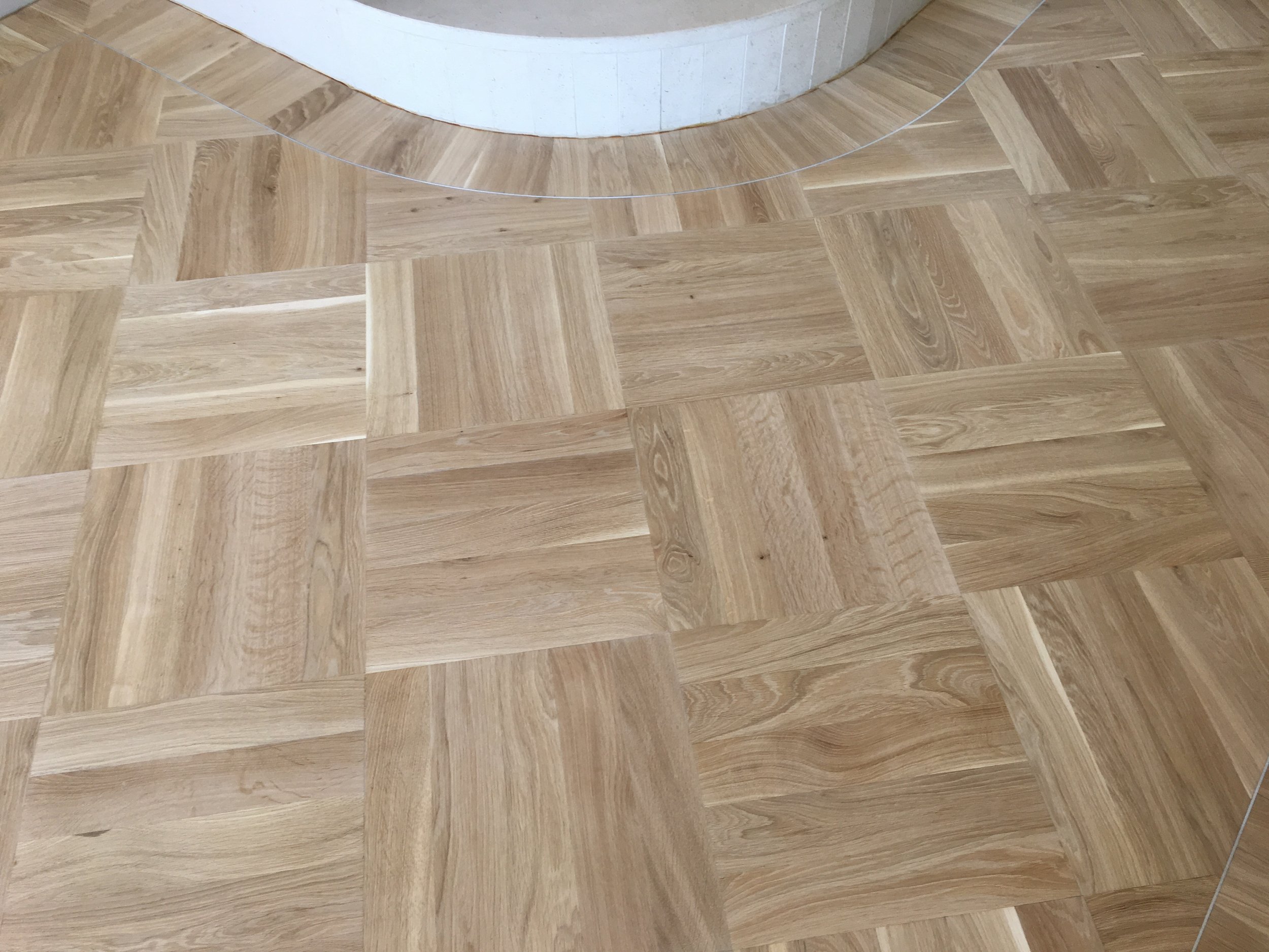  White Oak parquet laid in square on square with a solider course border and aluminium inlay 