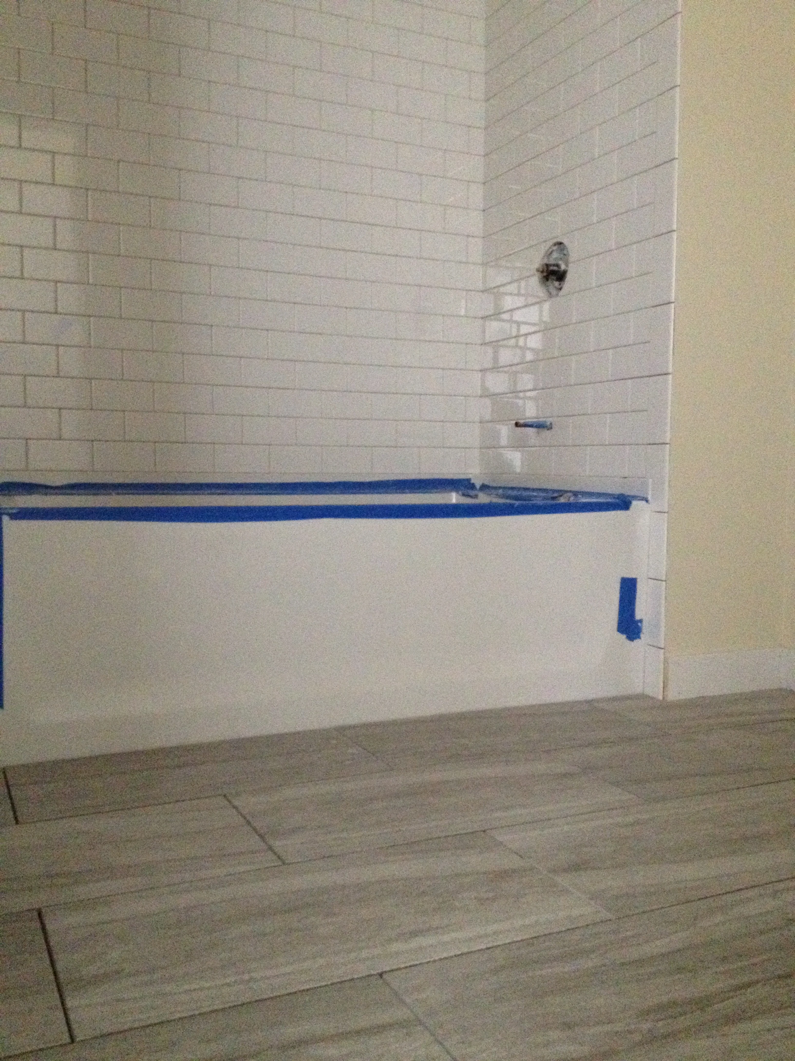 Tile surround and tile floors in Unit 101 bathroom.