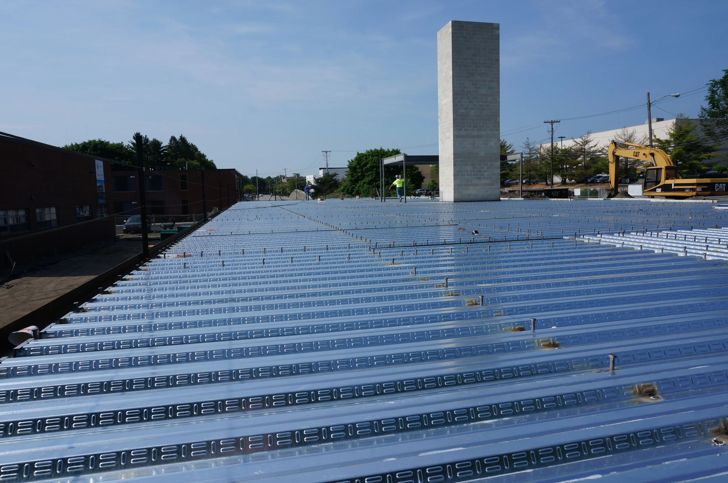 Steel deck with elevator shaft in the distance.