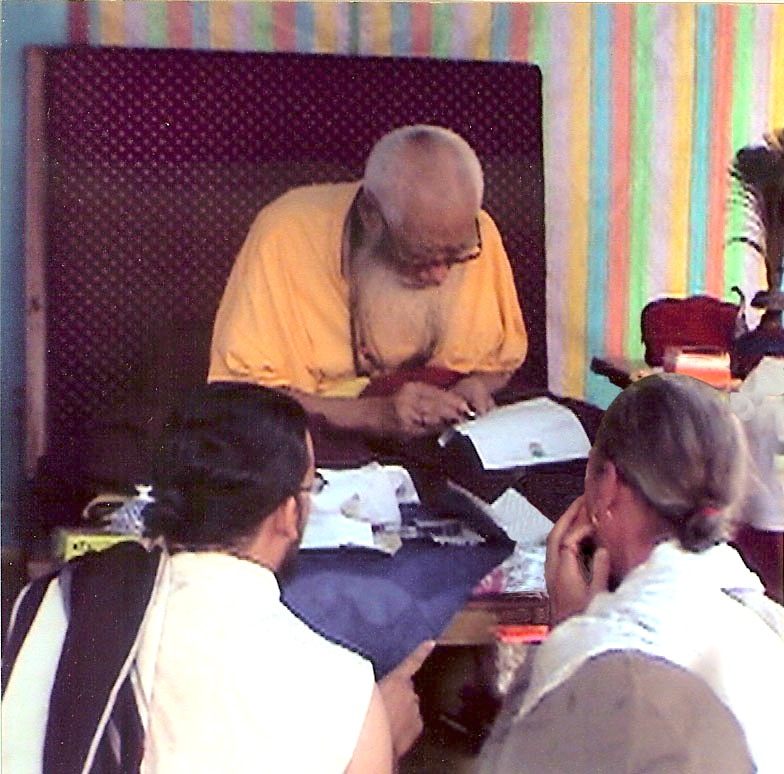 Kyabje Chatral Sangye Dorje Rinpoche writing with the new pen offered by Lama Padma Karma.