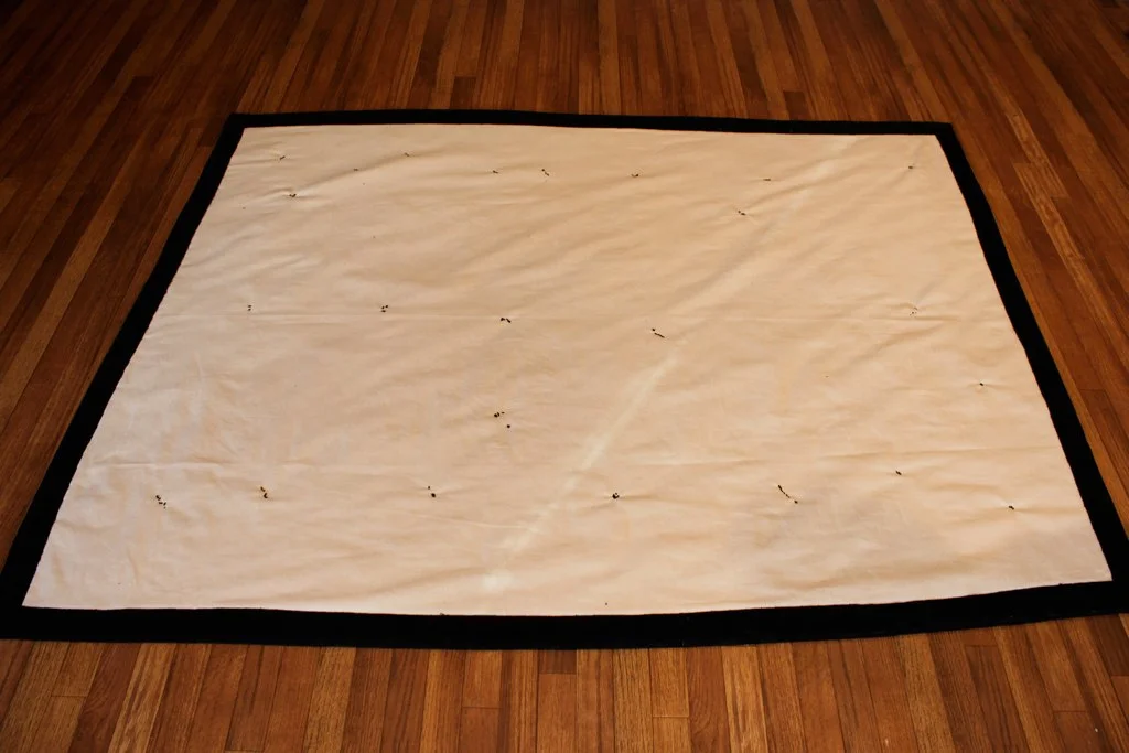 Rug after hand stitched cotton backing