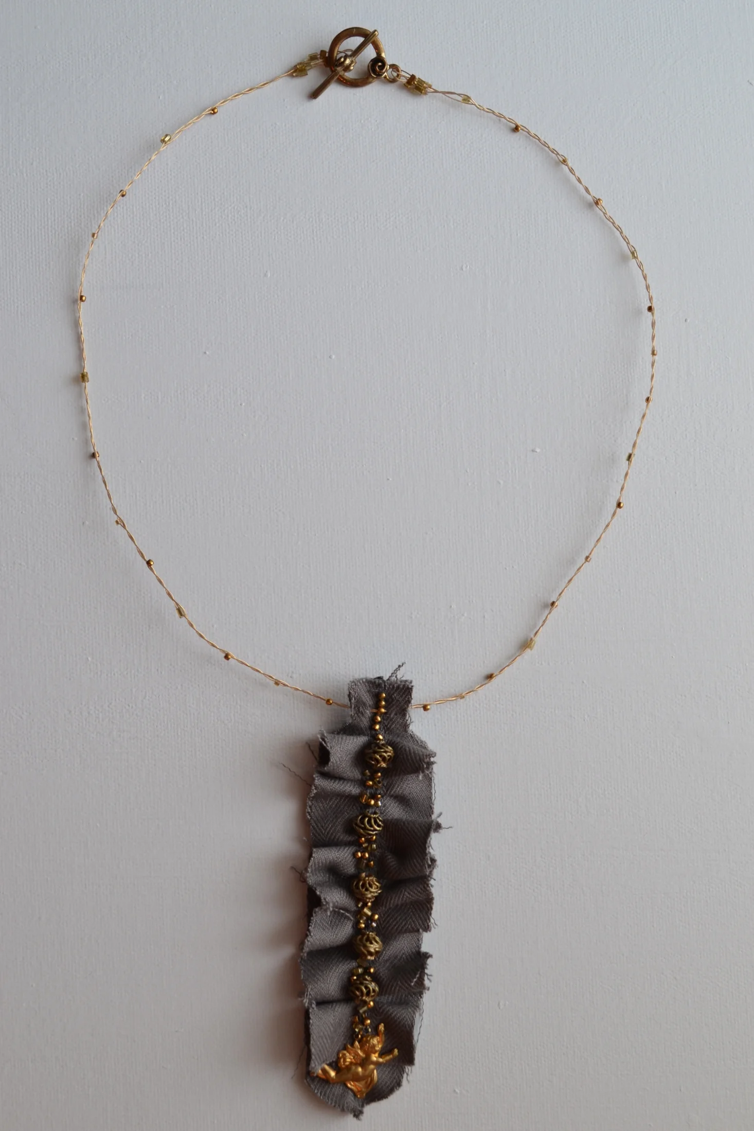 Arrow Style necklace from L.E.W. designs. Grey fabric and  gold color accents. Click through for more information. (4).JPG