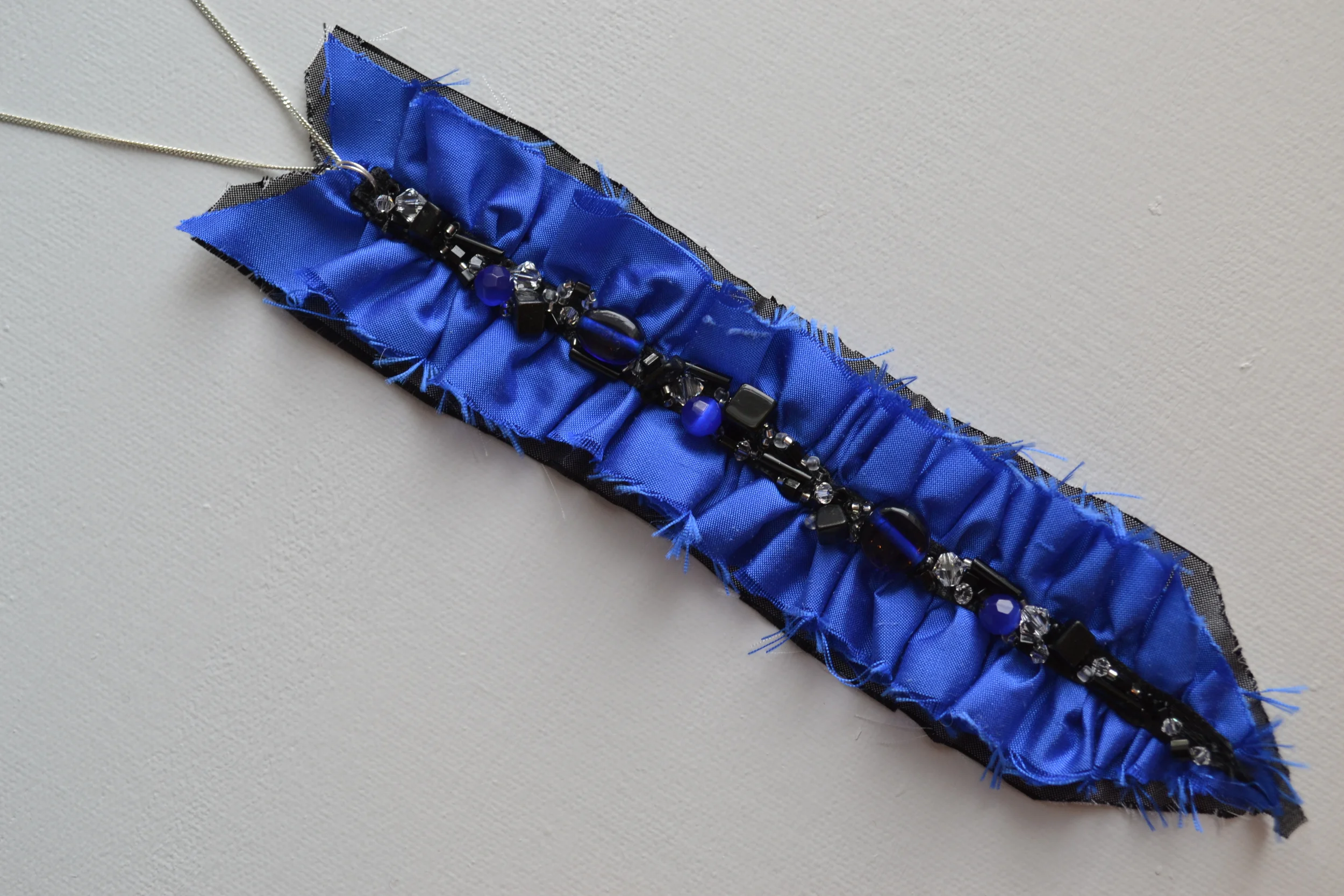 Arrow Style necklace from L.E.W. designs. Bright blue silk with a SS chain. Click through for more info.JPG