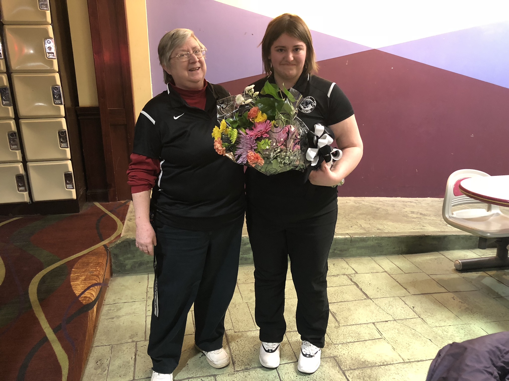Elms Bowling Coach Pat Kelley congratulates Rachael Saepic during the team's senior night celebration.