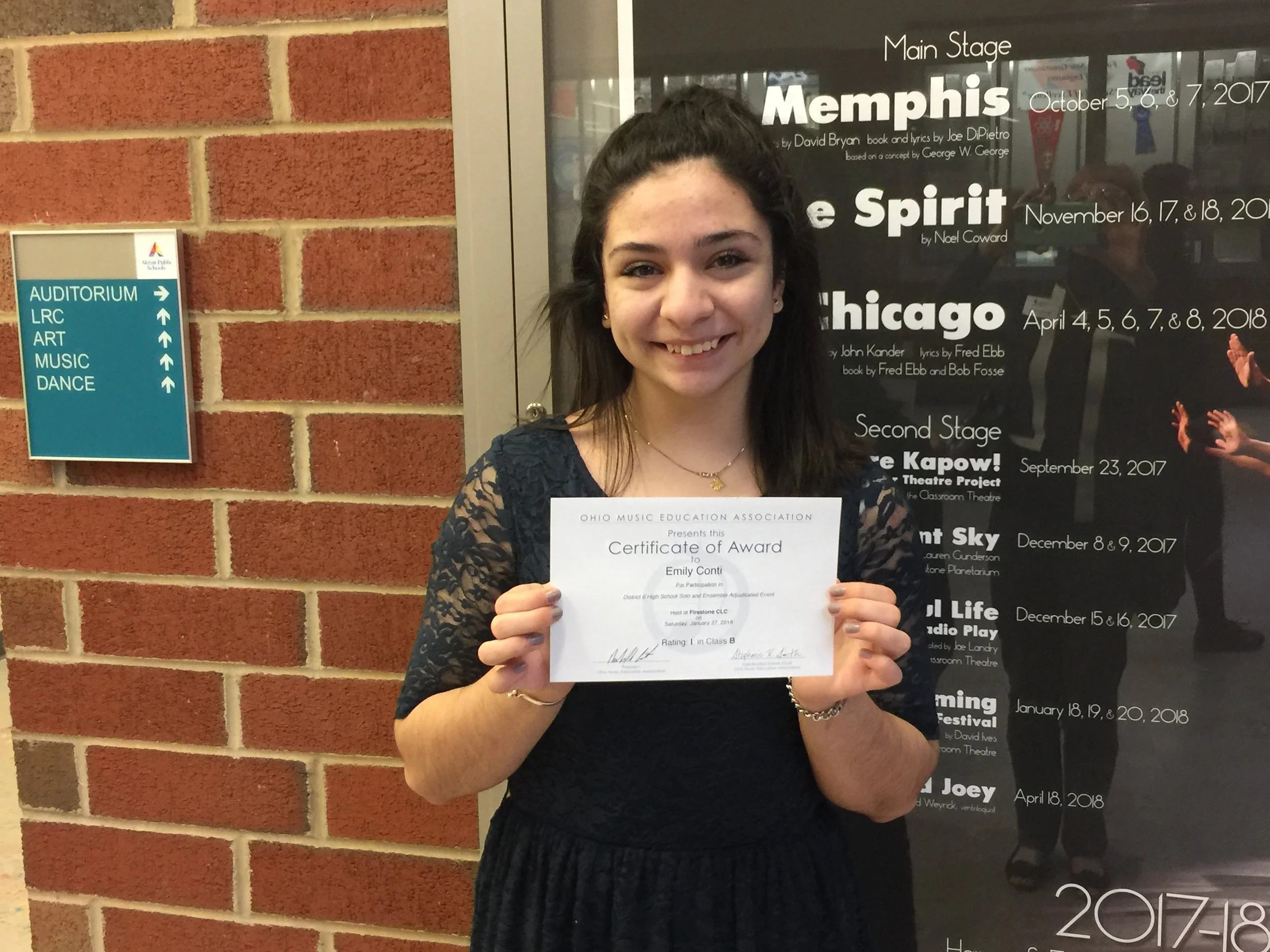 Emily Conti poses with her certificate after receiving a Superior rating for her vocal solo.