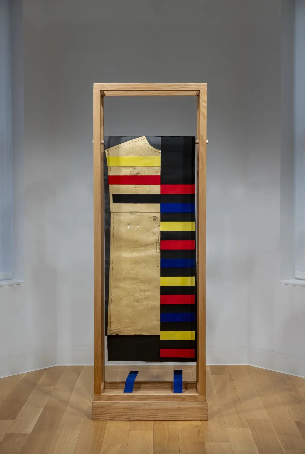  Pose 2. 2017.  
 
Acrylic paint, clothing patterns, fabric, paper, painted aluminum, oak, plexiglass. 72 in. x 24 in. x 12 in. From the “Moodboard” series. 