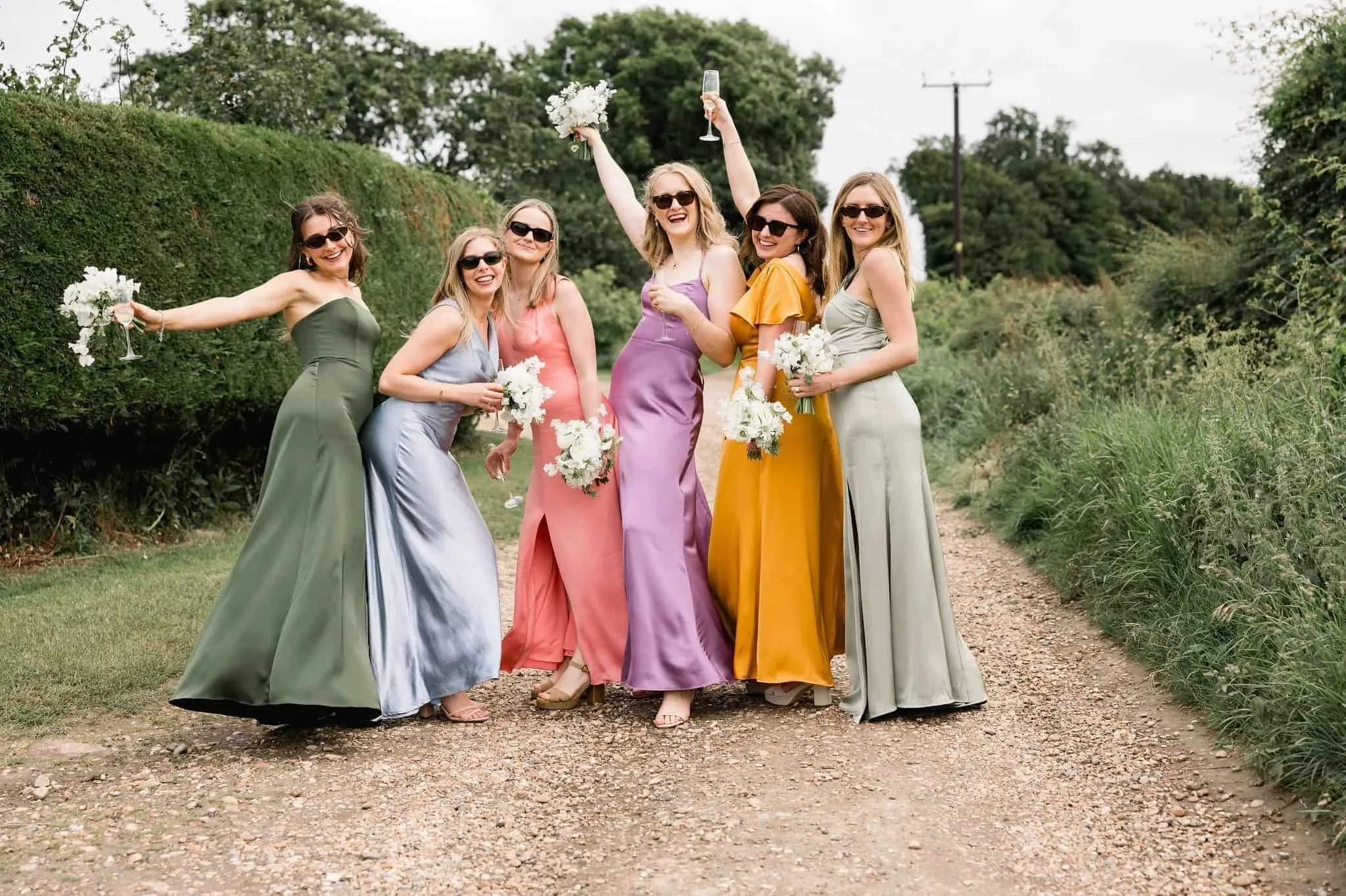 Colorful bridemaids and their bouquets by Flowers in Rye by Rye Florist Alex Ball
