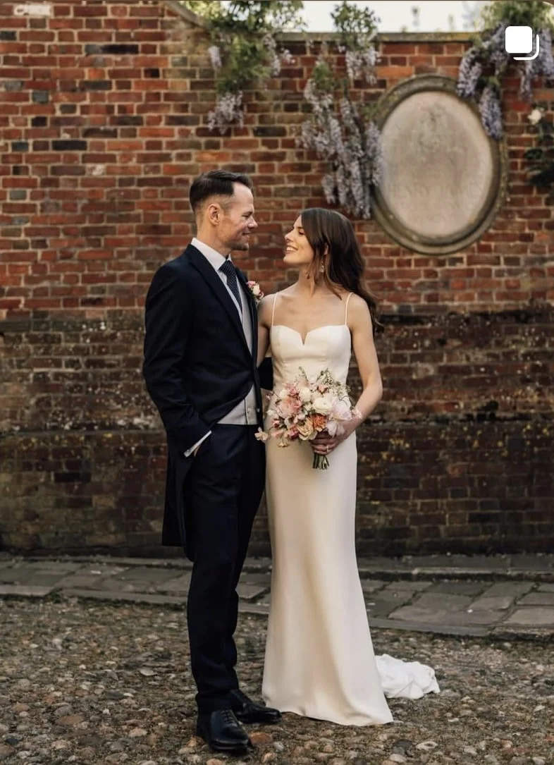 A happy couple posing for photographs in the historic Rye Citadel