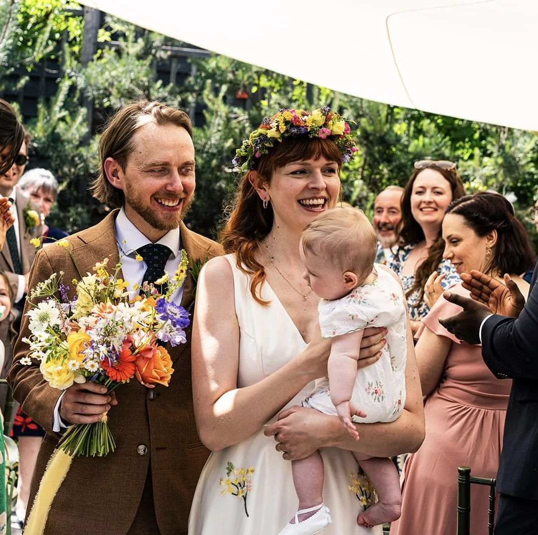 Courtyard wedding at the George in Rye, bright coloured flowers and lots of fun.