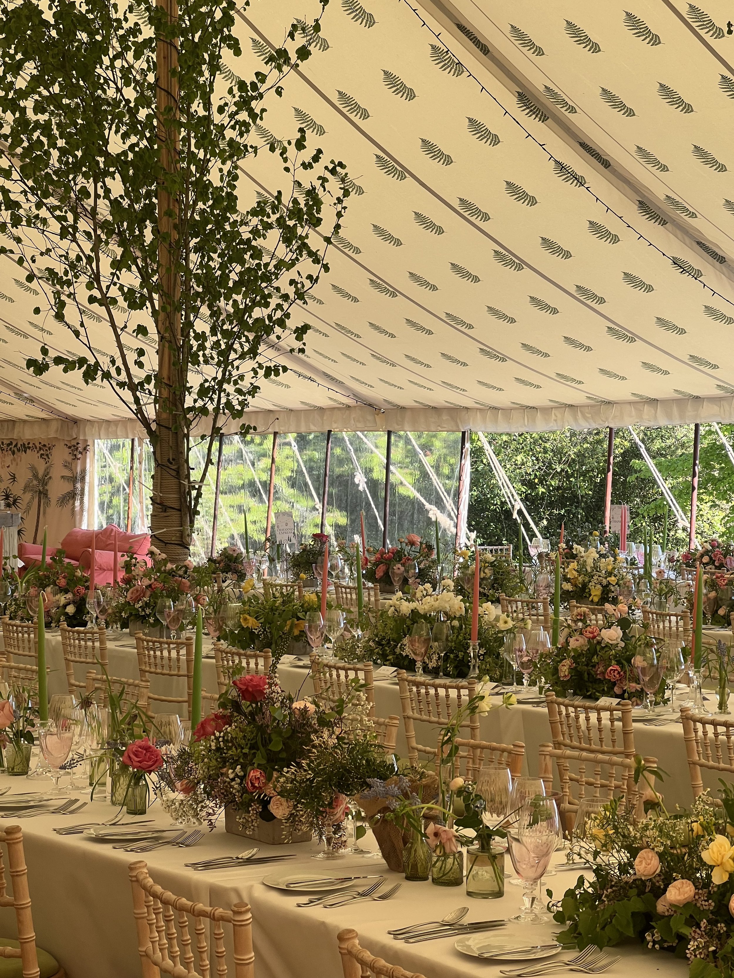 A beautiful luxury wedding, with reception tables overflowing with spring flowers