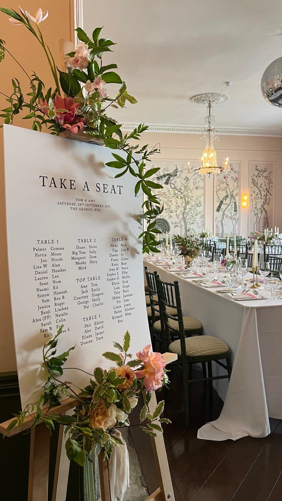 this picture depicts a typical George Wedding Reception in the Ballroom, it features a guest table plan decorated with florals by Alex Ball Rye Florist