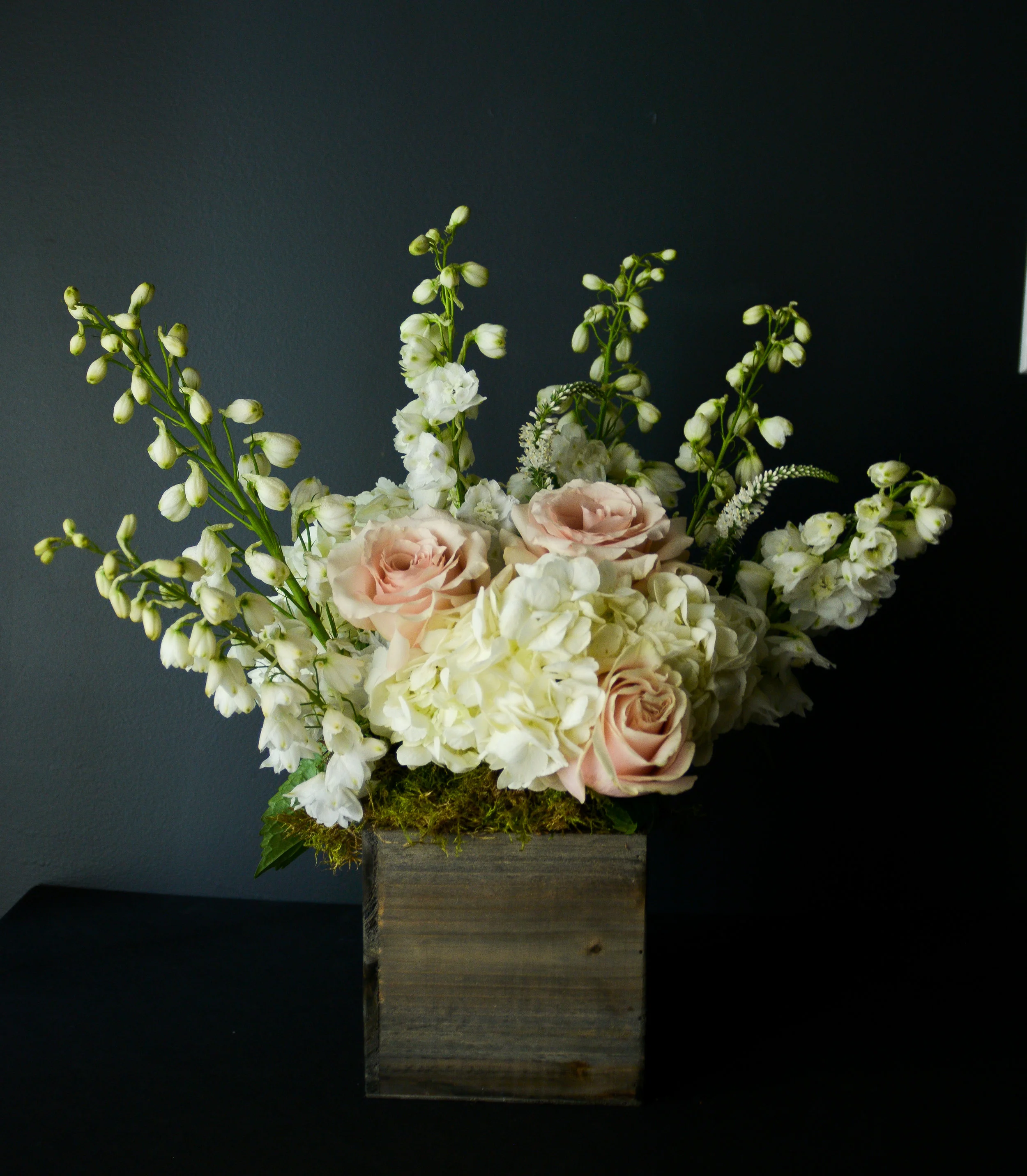 $100 Arrangement A beautiful bloom packed arrangement, filled to the brim with buds and wisps, great as a centerpiece for a small table, or as a thoughtful gift to a kindred spirit, coworker, or boss.