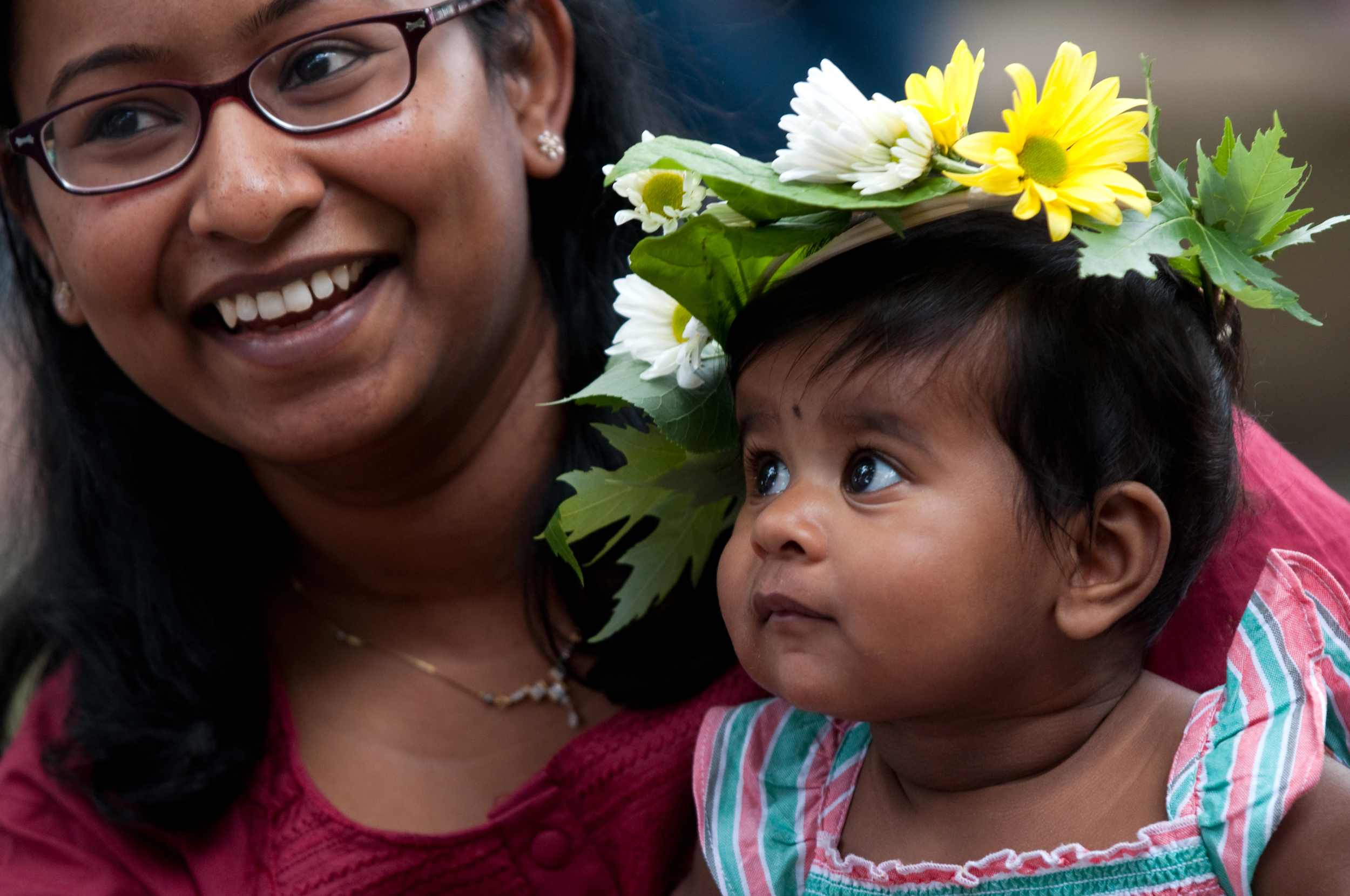A mother places a handmade flower wreath on her daughter's head at the Harvard Museums of Science and Culture's Summer Solstice Celebration. Copyright © 2015 President and Fellows of Harvard College