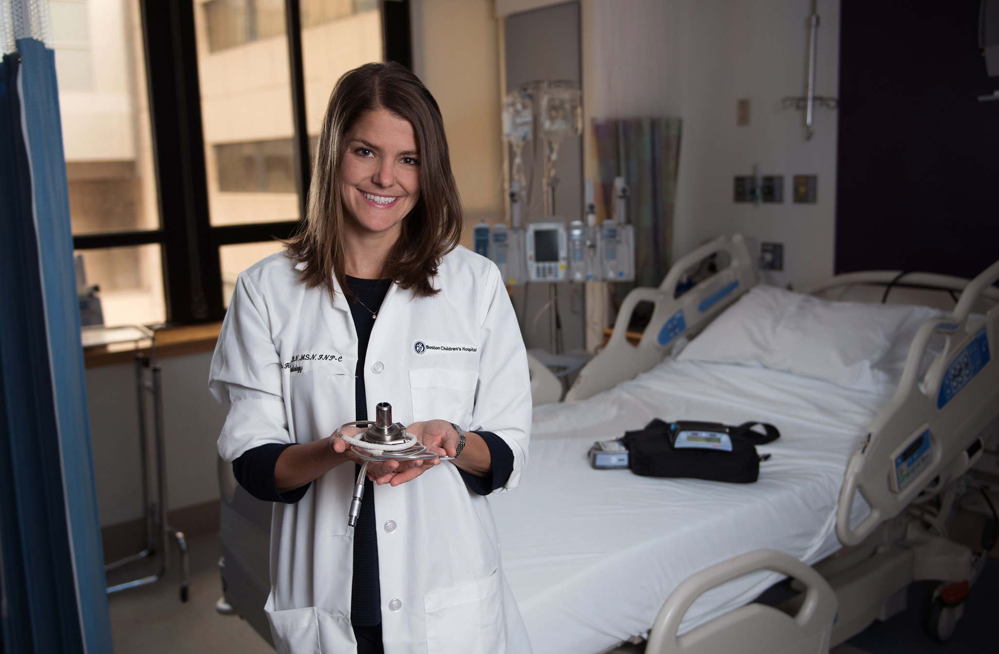 Beth Hawkins, RN, holds a ventricular assist device (VAD).