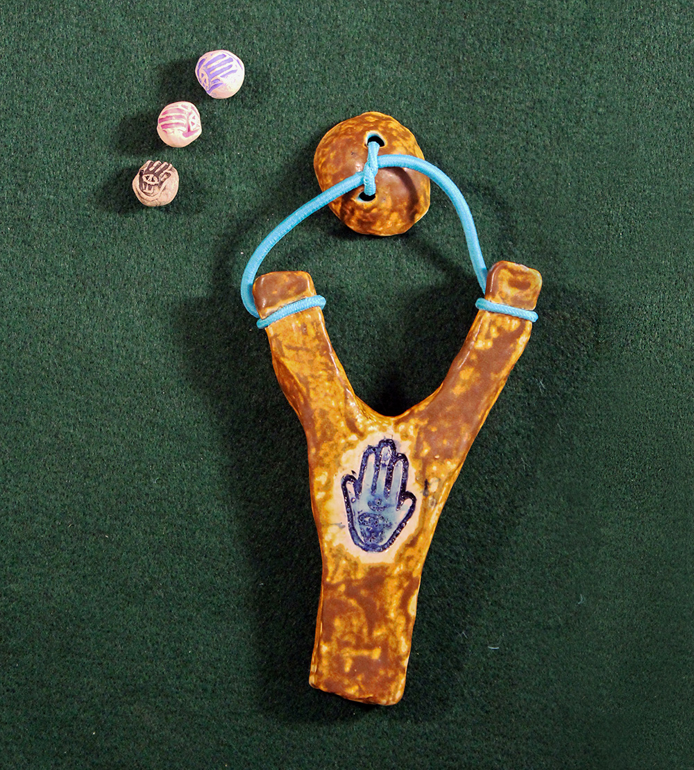  Pea Shooter  Guy Ben-Ari &amp; Leah Wolff,  The Best Defense is a Good Hamsa , 2012, Clay and glaze 