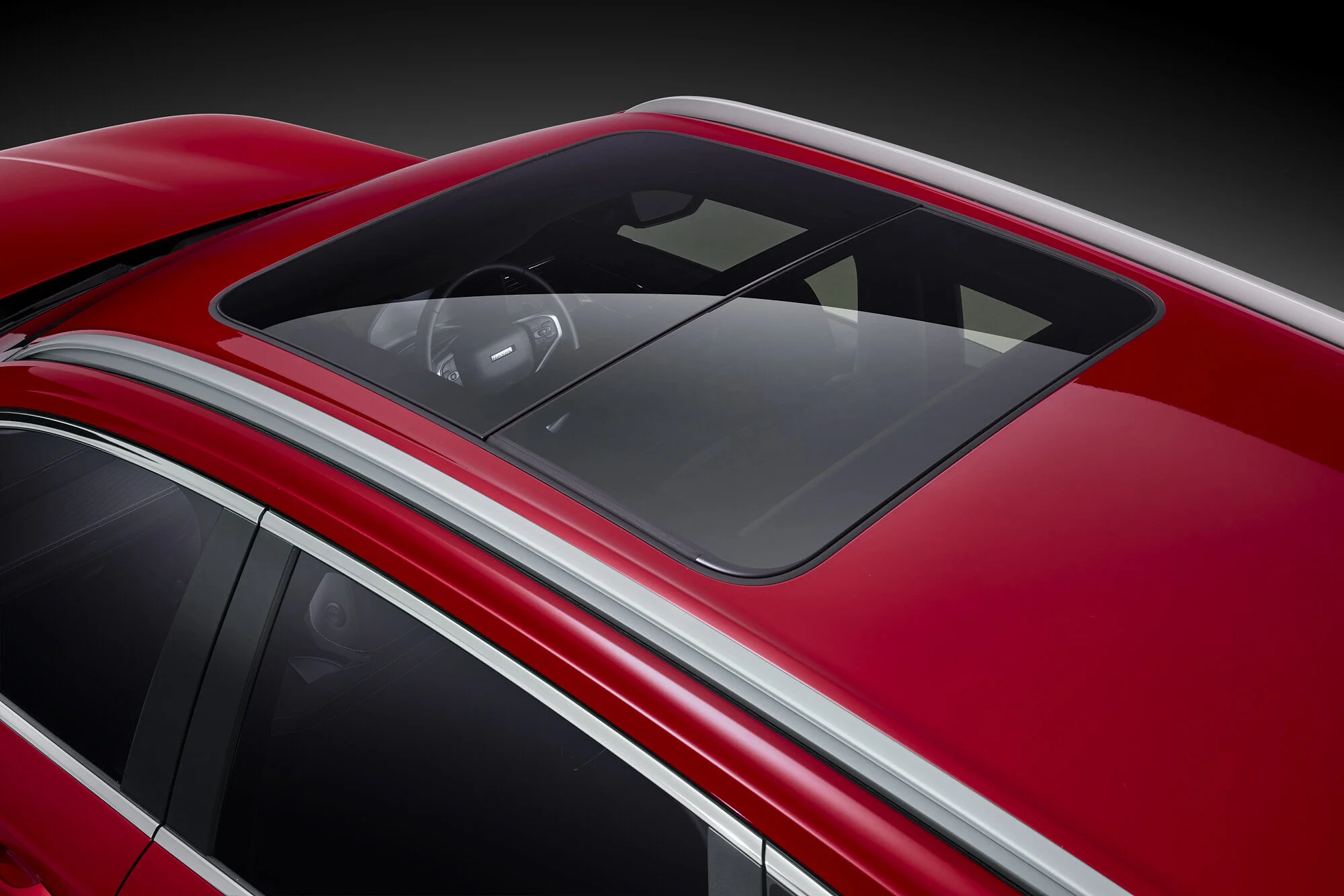 Studio automotive photography showing controlled reflections and highlights across vehicle paintwork and glass.