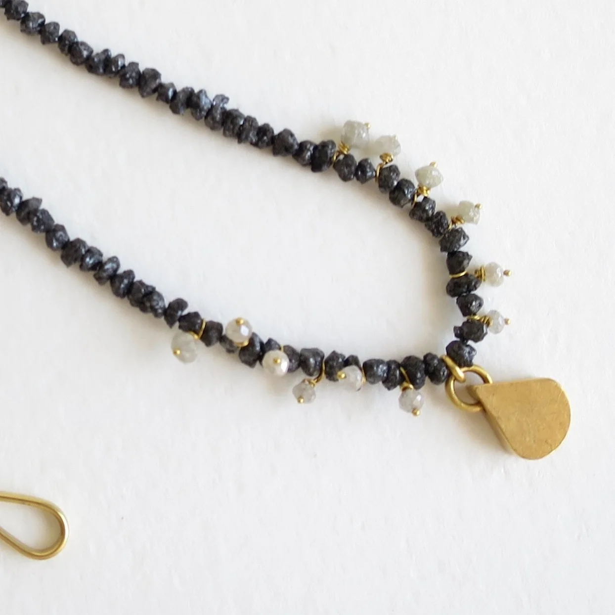 Jewelry Jewellery Rough black and white diamond necklace, 18kt gold and 22kt gold drop.