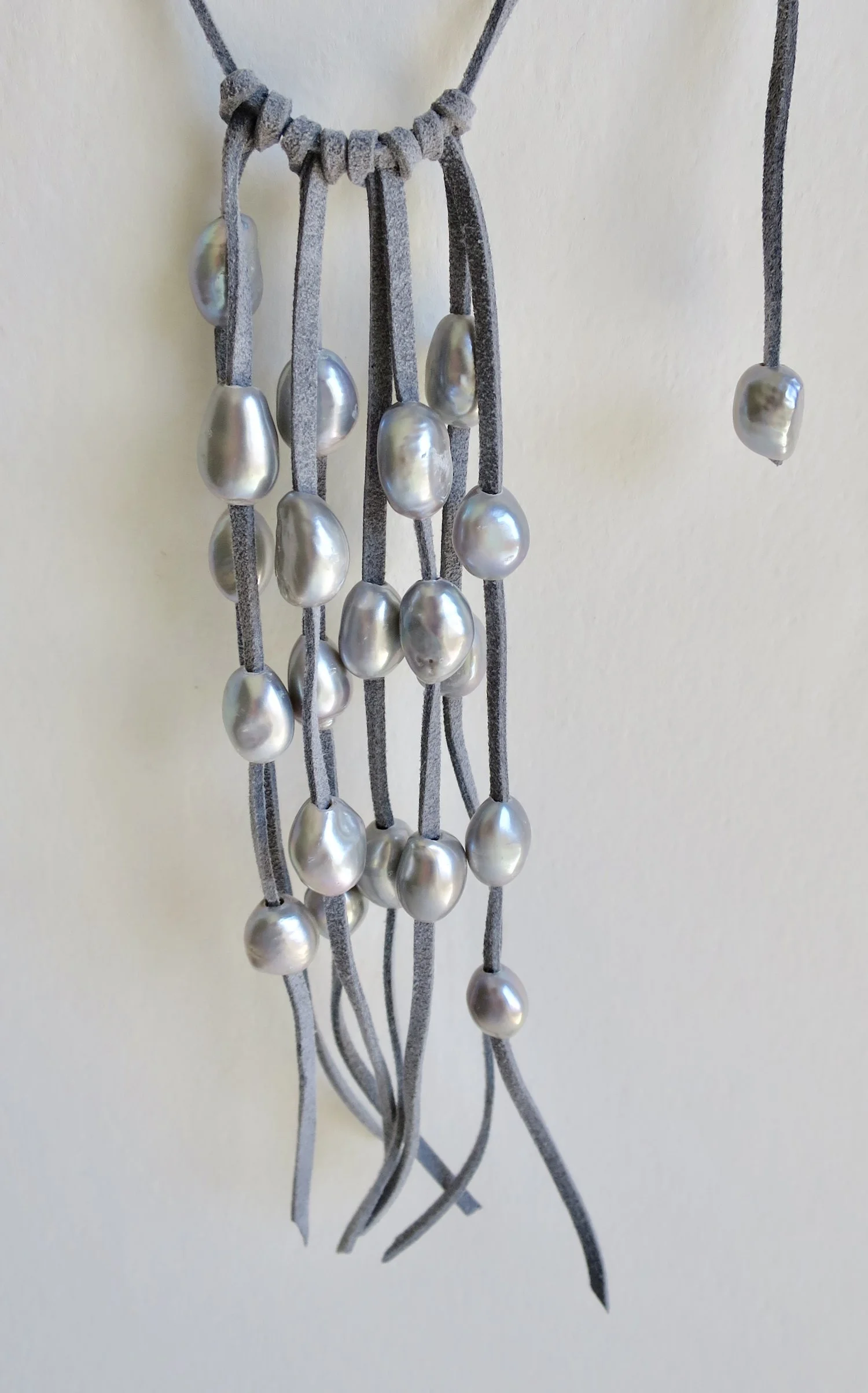 Pearl cascade on blue suede tie necklace with one pearl backdrop