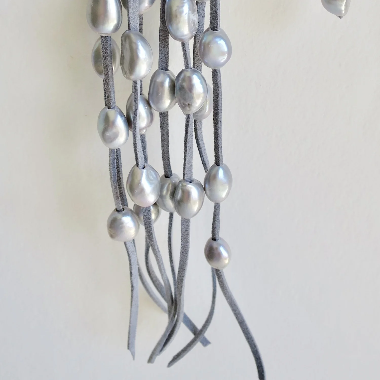 Jewelry Jewellery Grey pearl cascade on blue suede, tie necklace with backdrop