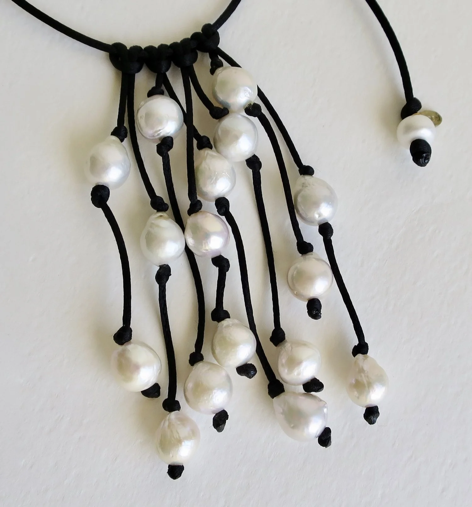 Cascade of pearls on black satin