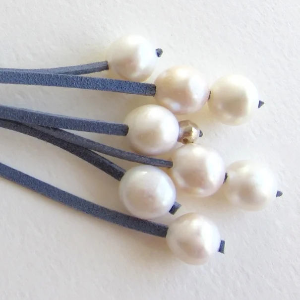 Jewelry Jewellery Pearl necklace on blue suede