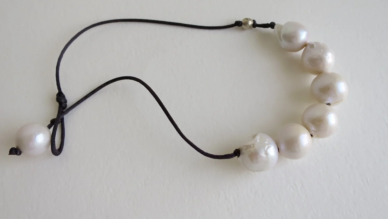 Round white pearls on Satin