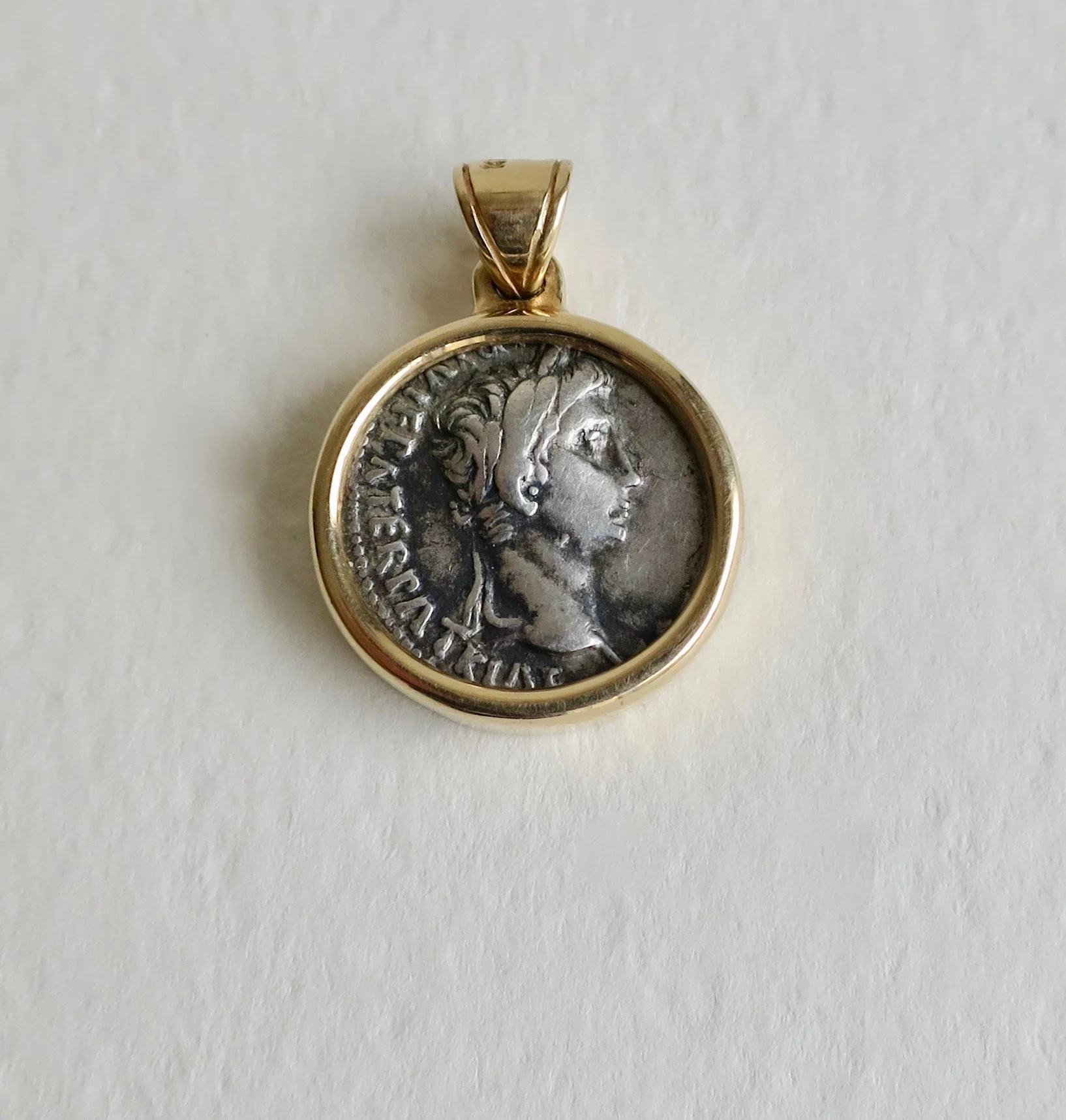 Silver denarius set in 14kt gold pendant