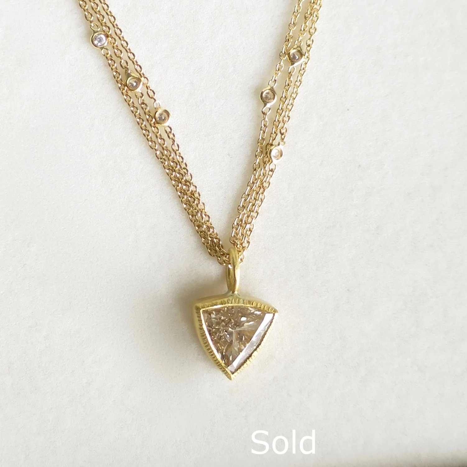 Jewelry Jewellery Trilliard diamond pendant set in 22kt gold on triple gold diamond chain