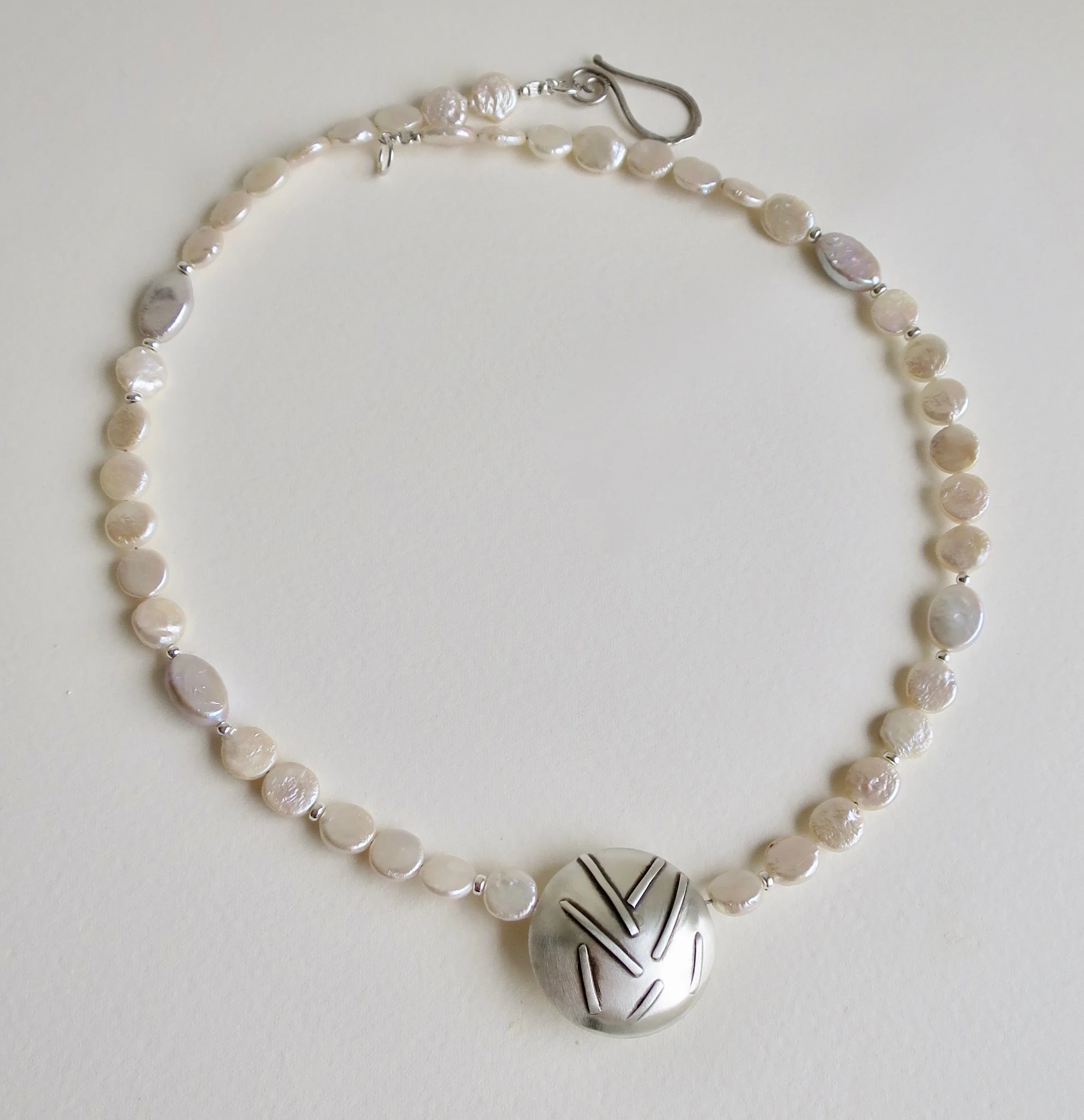 Flat pearl necklace with hand made silver centrepiece 