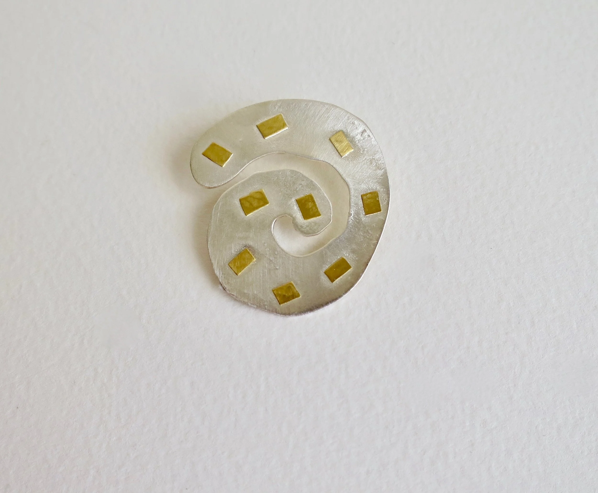 Fine silver spiral brooch with 22ct gold