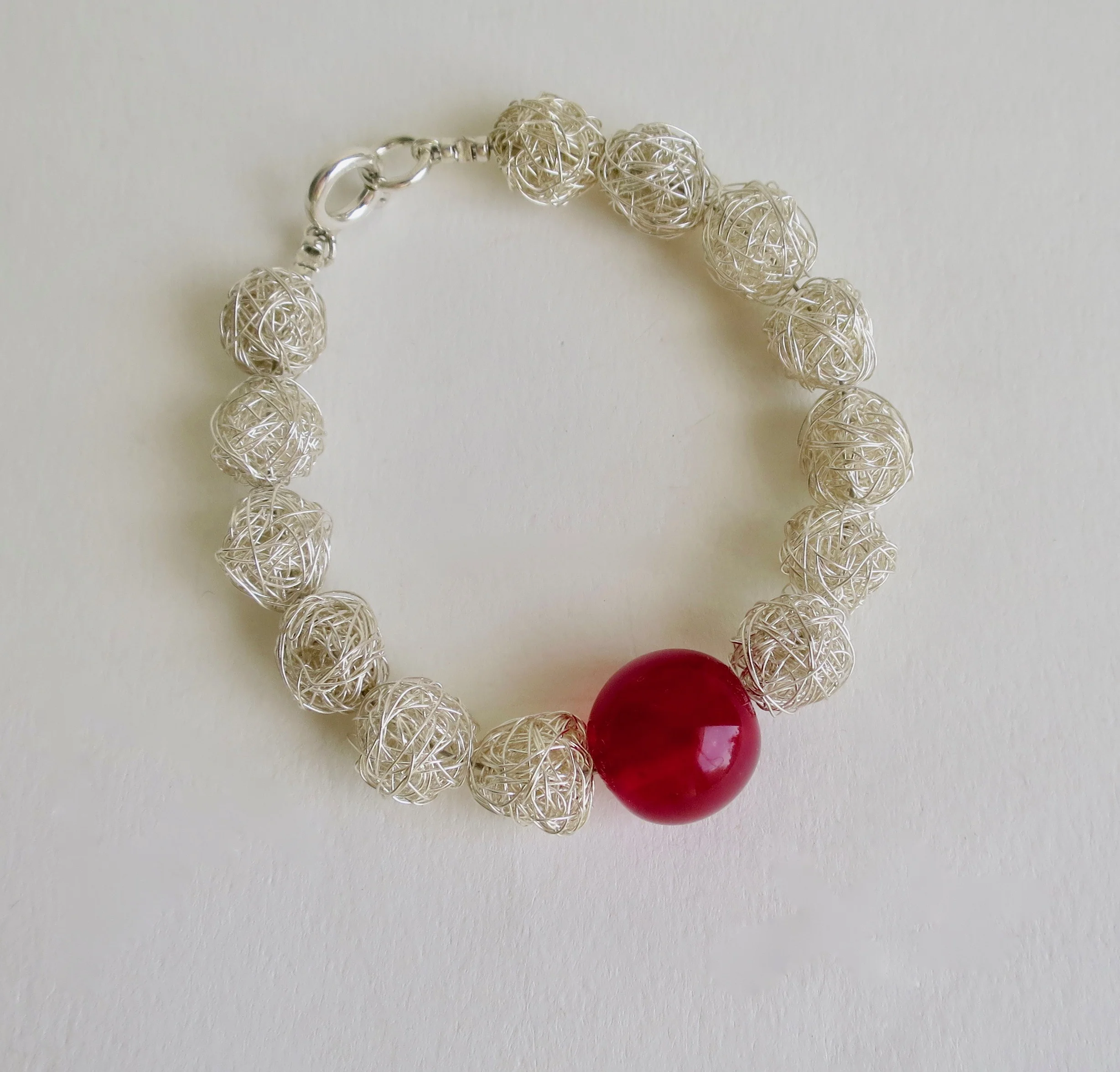 Silver plonter bracelet with red blown glass