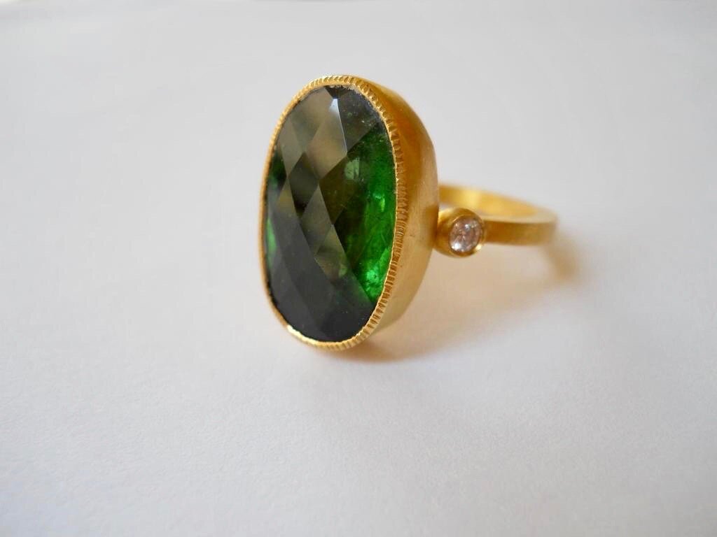 Green tourmaline ring with diamonds set in 22 carat gold