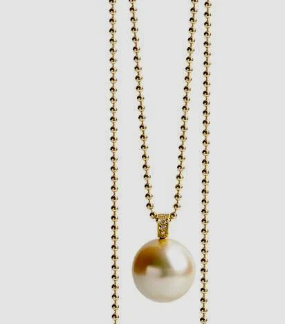 Rare Golden South Sea round pearl and gold pendant with natural diamonds set in bail