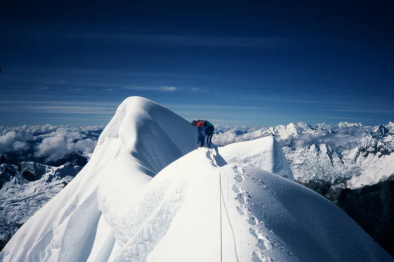 Traversing the precarious summit ridge of Alpamayo, Peru